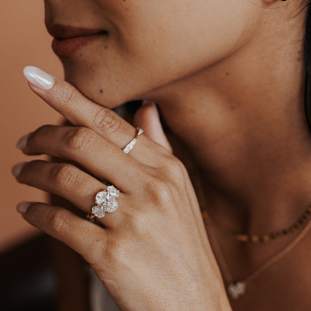 The Hannah Oval Ring in 14k yellow gold worn on the ring finger, styled with a diamond band on the index finger.
