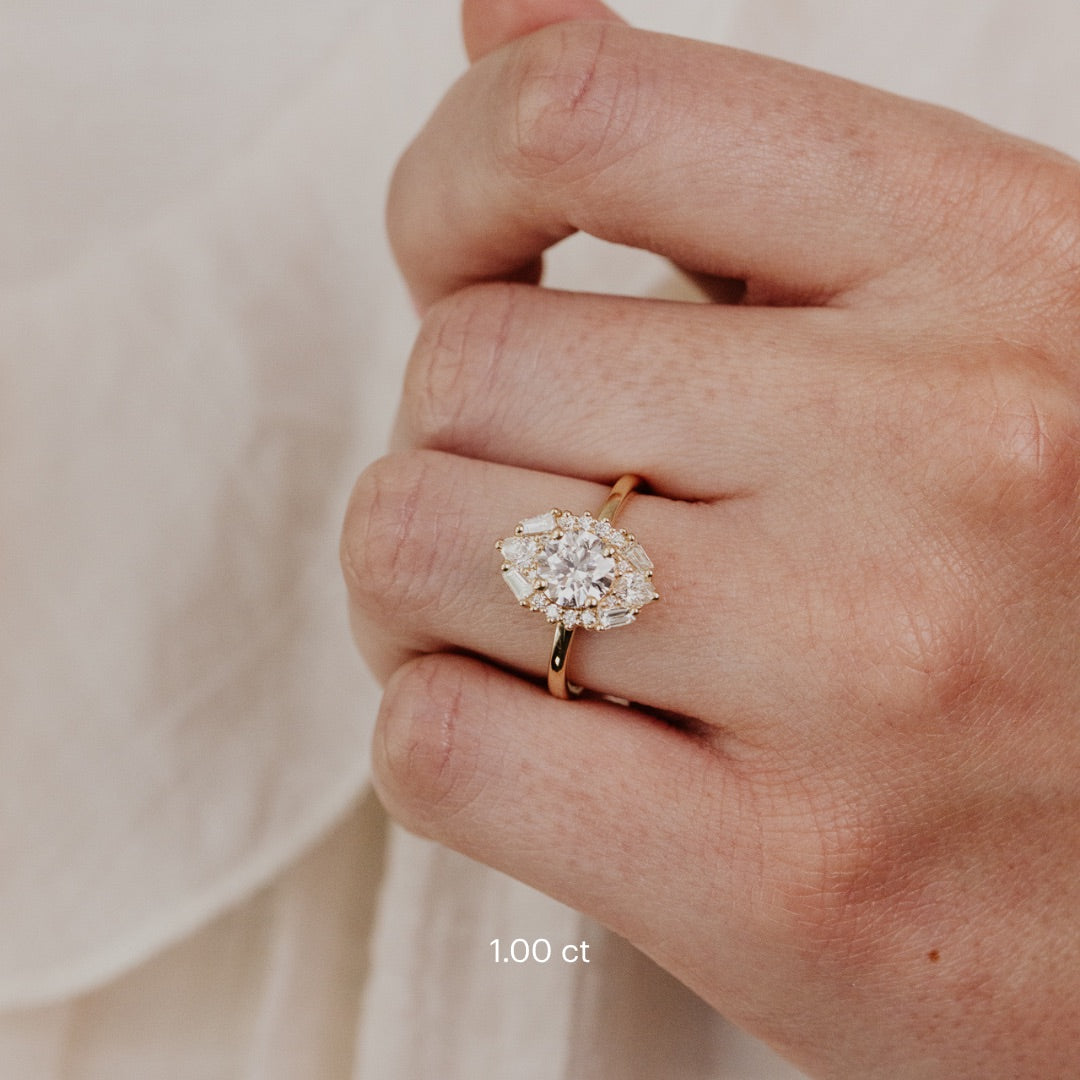 The Lori Round Ring in 14k yellow gold worn on the ring finger, shown in the 1.00 ct center stone size.
