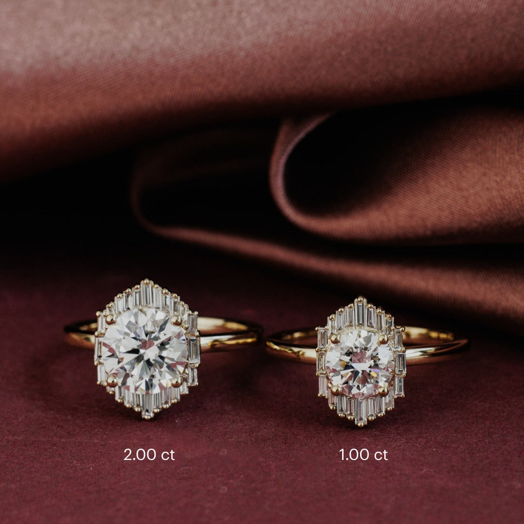 The North Star Ring in 14k yellow gold shown in two center stone size options: 2.00 ct (left) and 1.00 ct (right), displayed on draped brown satin fabric.