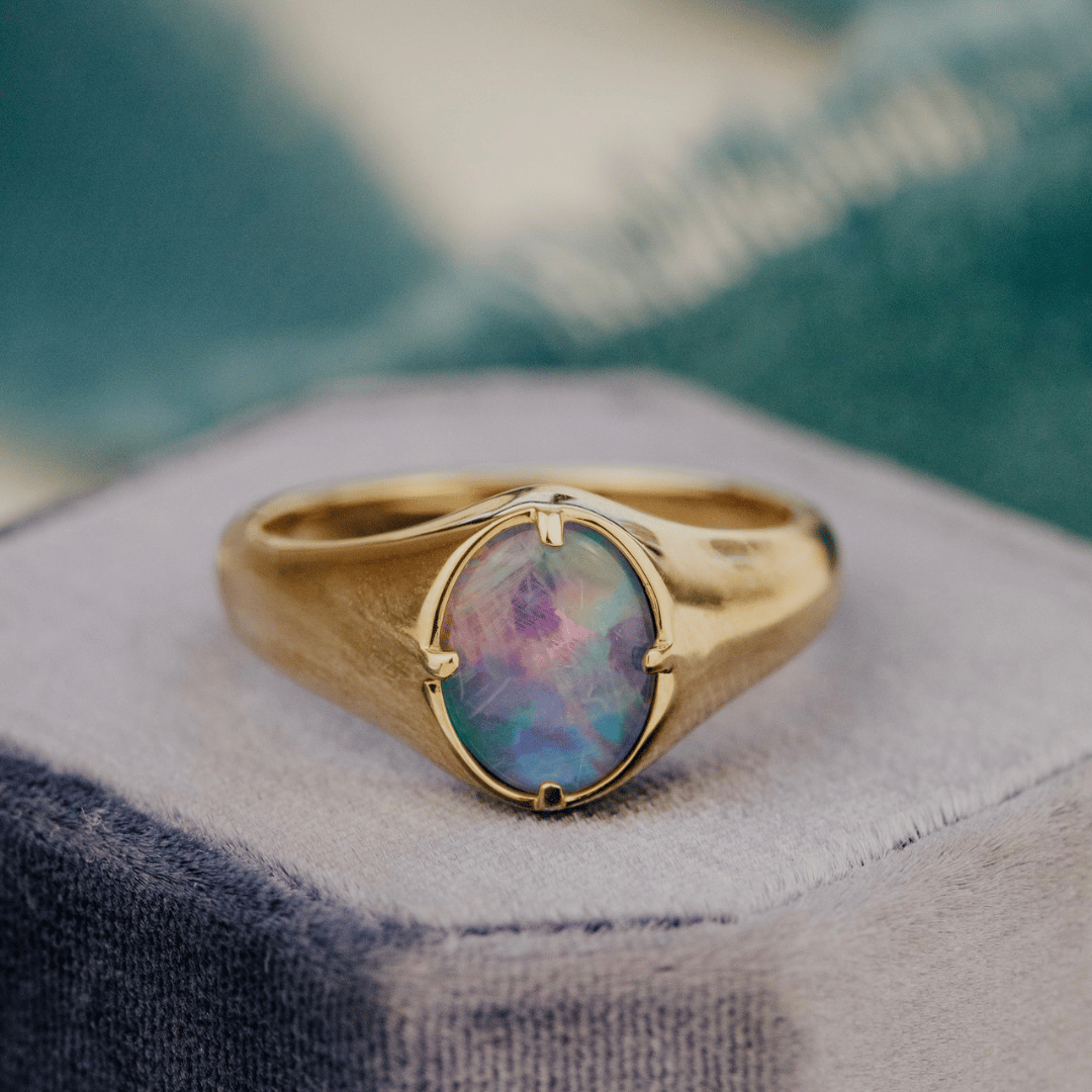 Triplet Opal 1.30 ct Signet Ring on a velvet ring box.