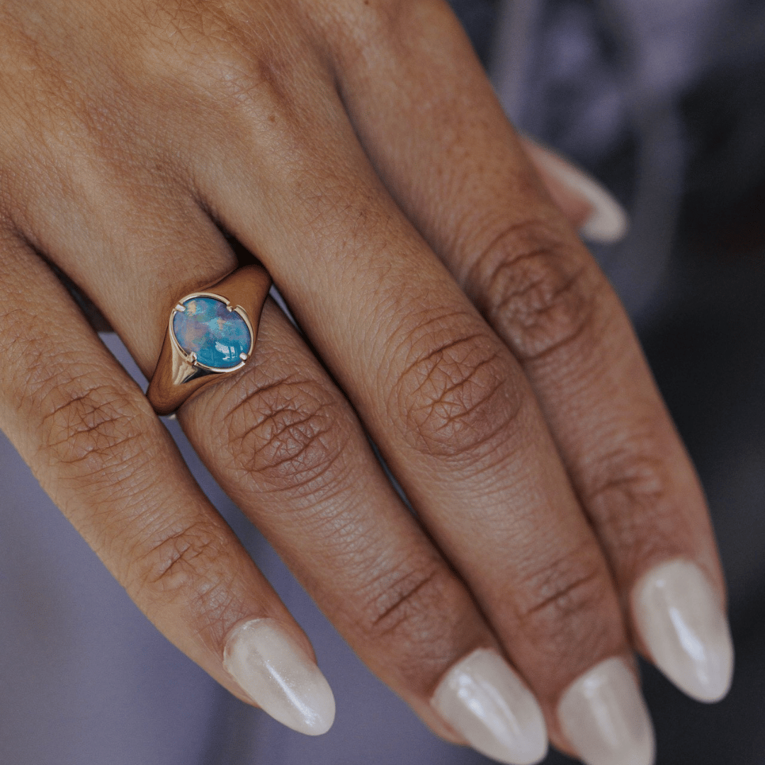 Opal Triplet signet ring on models hand.