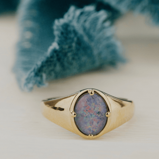 Triplet Opal Signet ring with white background. 