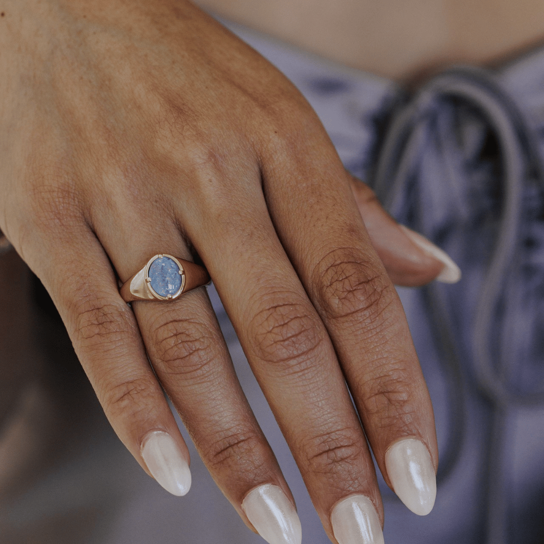 Opal triplet signet ring on a models hand. 