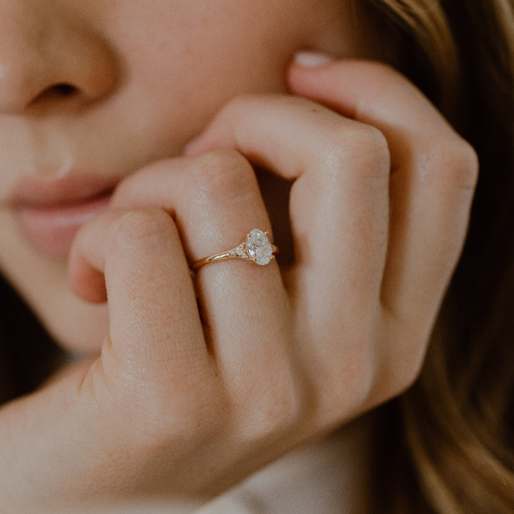 Close up of a model wearing the Angie oval diamond engagement ring.