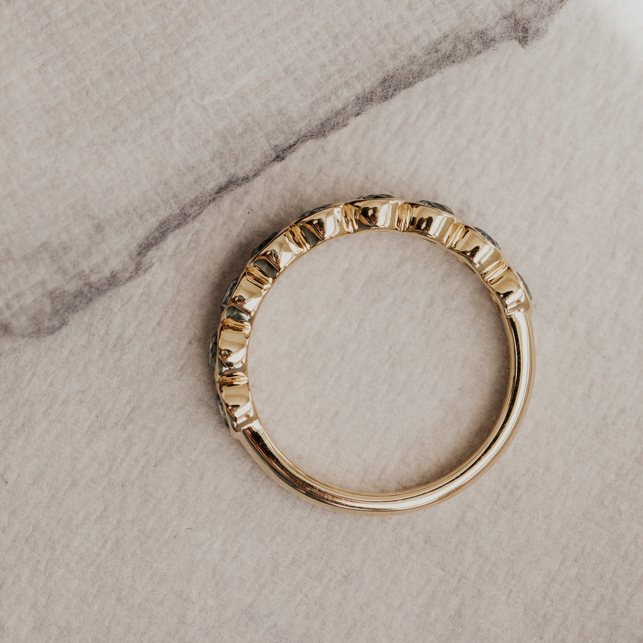 Top-down shot of a gold Aster Montana sapphire band.