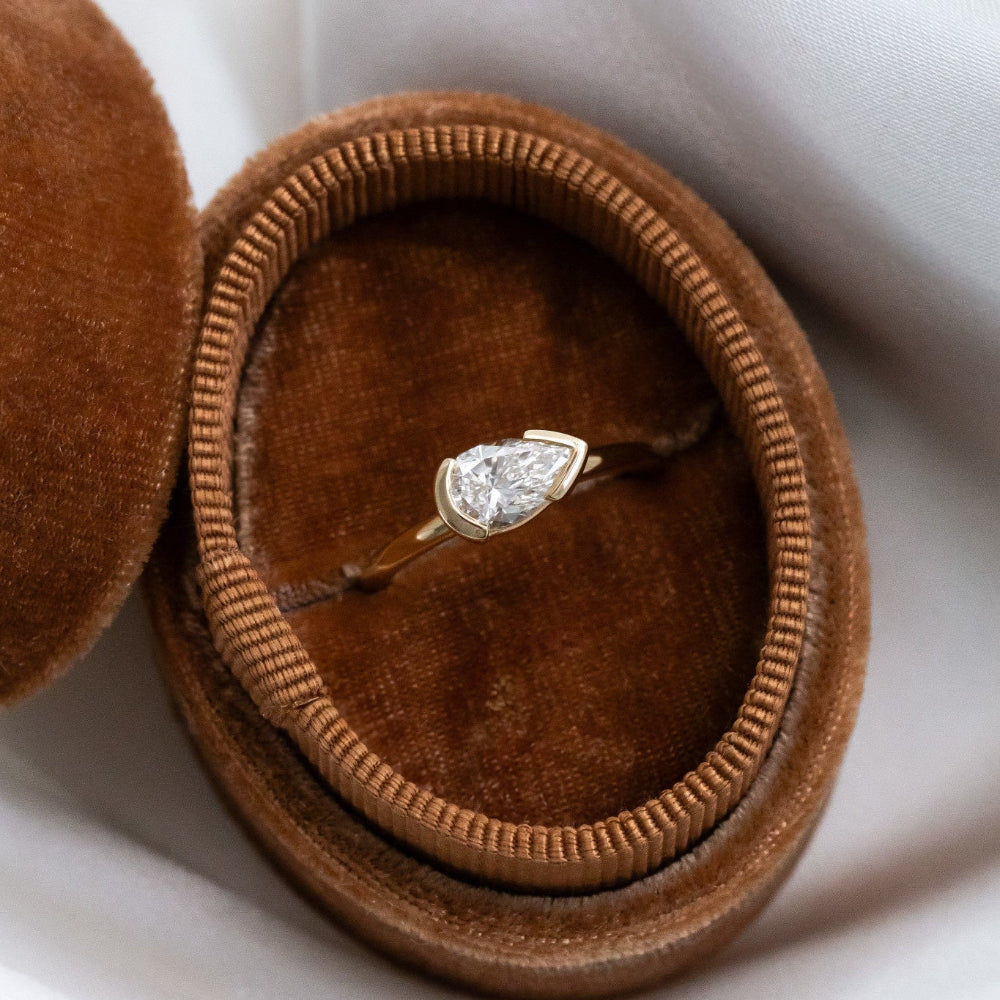 Diamond Austen diamond ring in a brown velvet box on a white background.