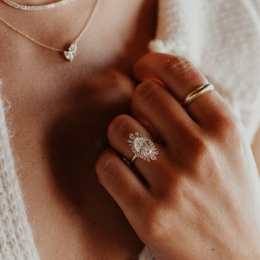 Close up of a hand wearing the Celeste oval diamond engagement ring.