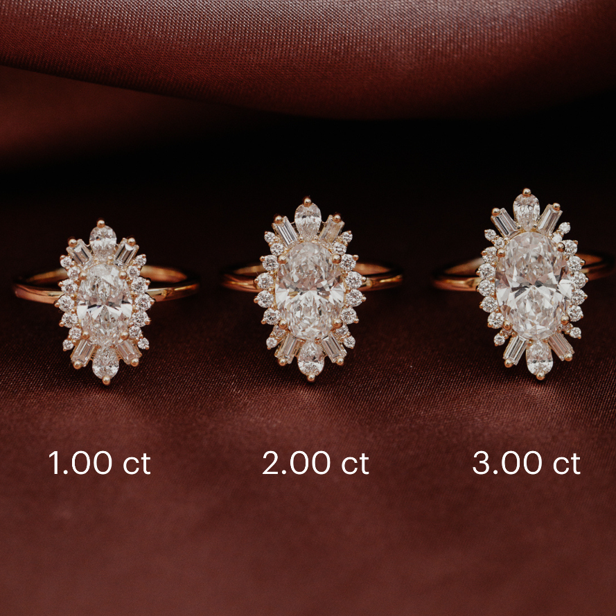 Three Celeste halo diamond rings with different carat weights on a brown fabric background.