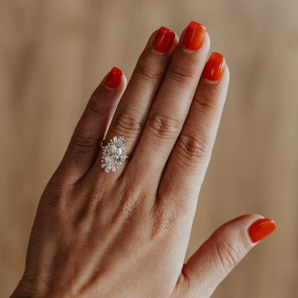 Close up of a hand wearing the Celeste oval diamond engagement ring.