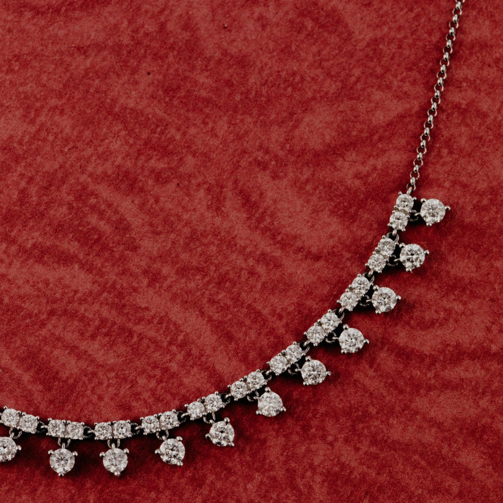 Diamond necklace on a red textured background.