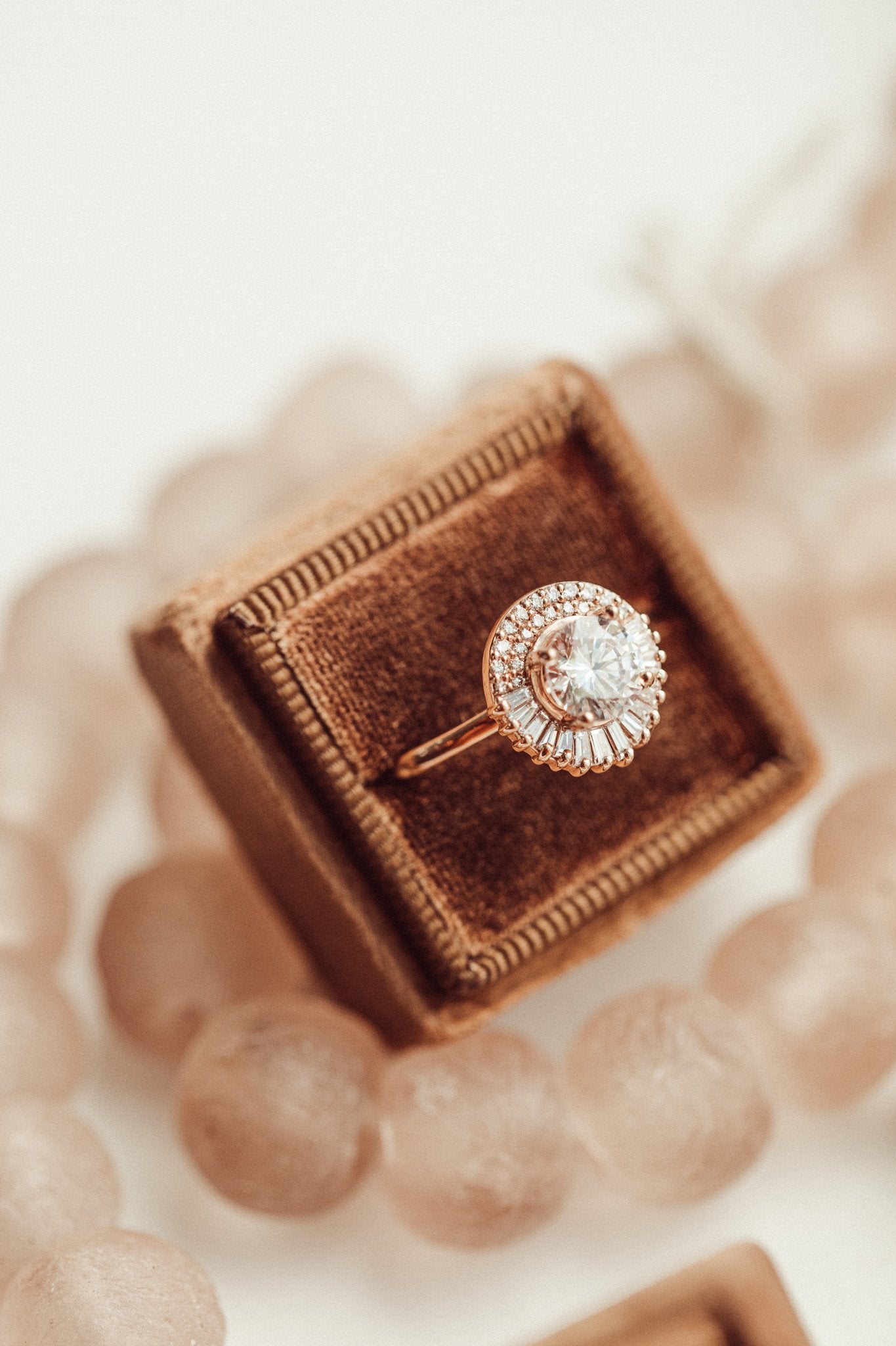 The Florence round diamond engagement ring in a brown velvet box.