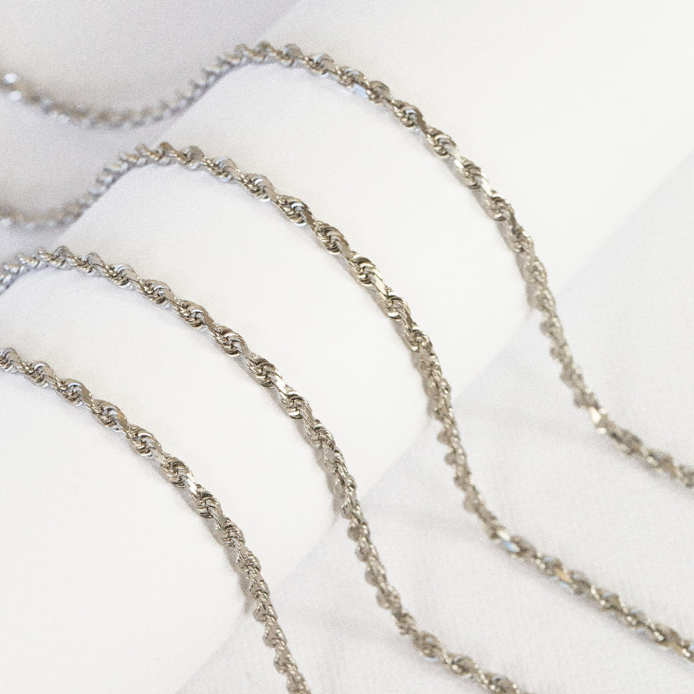 white gold chain necklace on a white surface