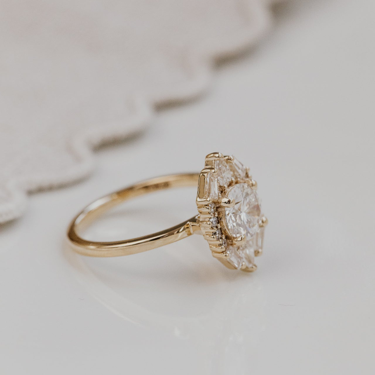 Lori round engagement ring with a diamond on a light background.
