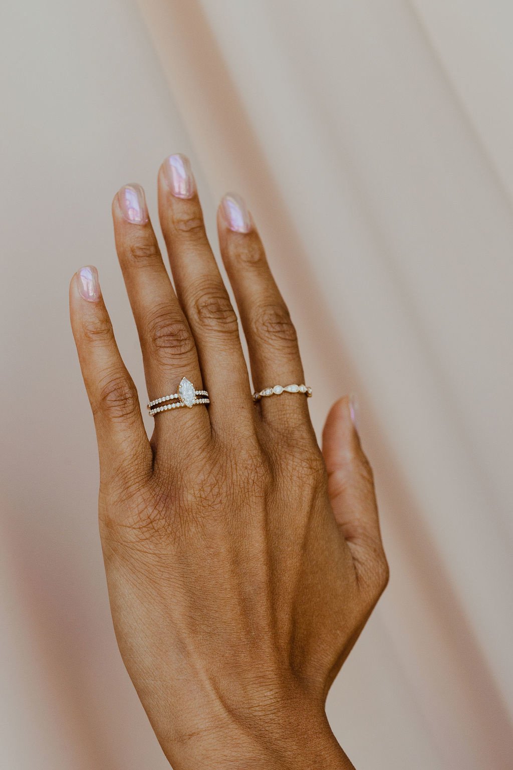 The Jenna Diamond Band on a models hand paired with The Jenna Marquise Ring