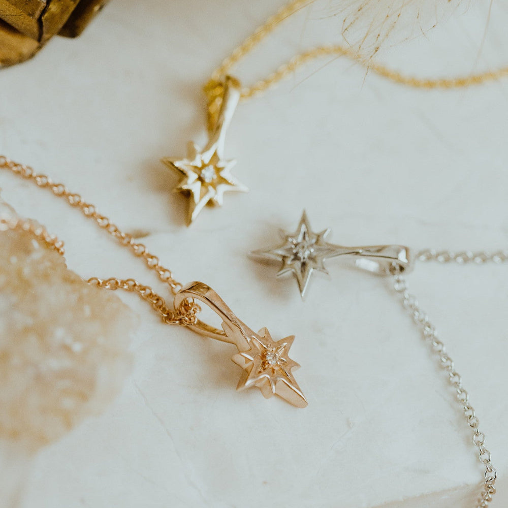 Gold  star-shaped jewelry on a marble surface
