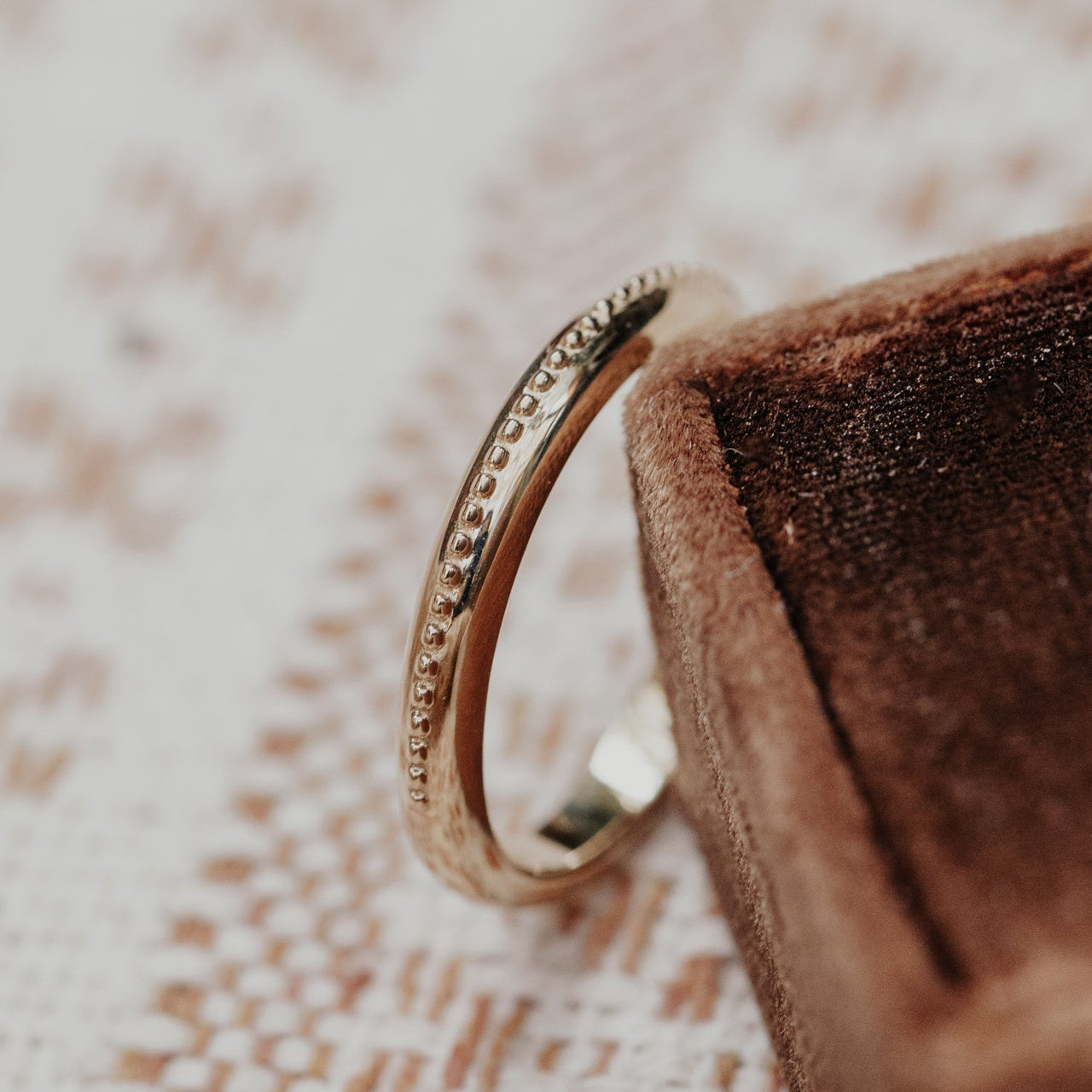 Gold ring on a textured surface