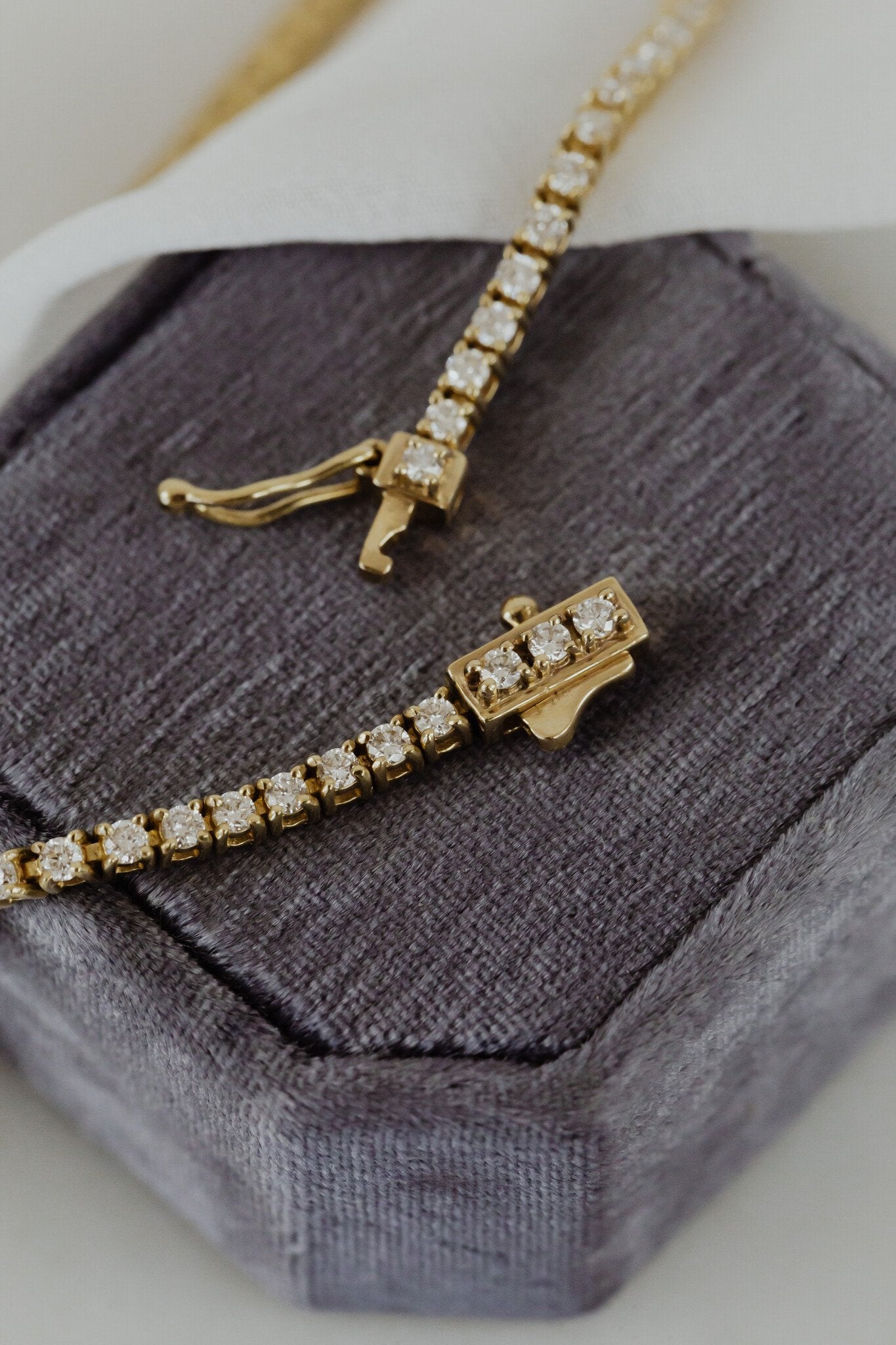 Close up of the security clasp on a diamond tennis bracelet.