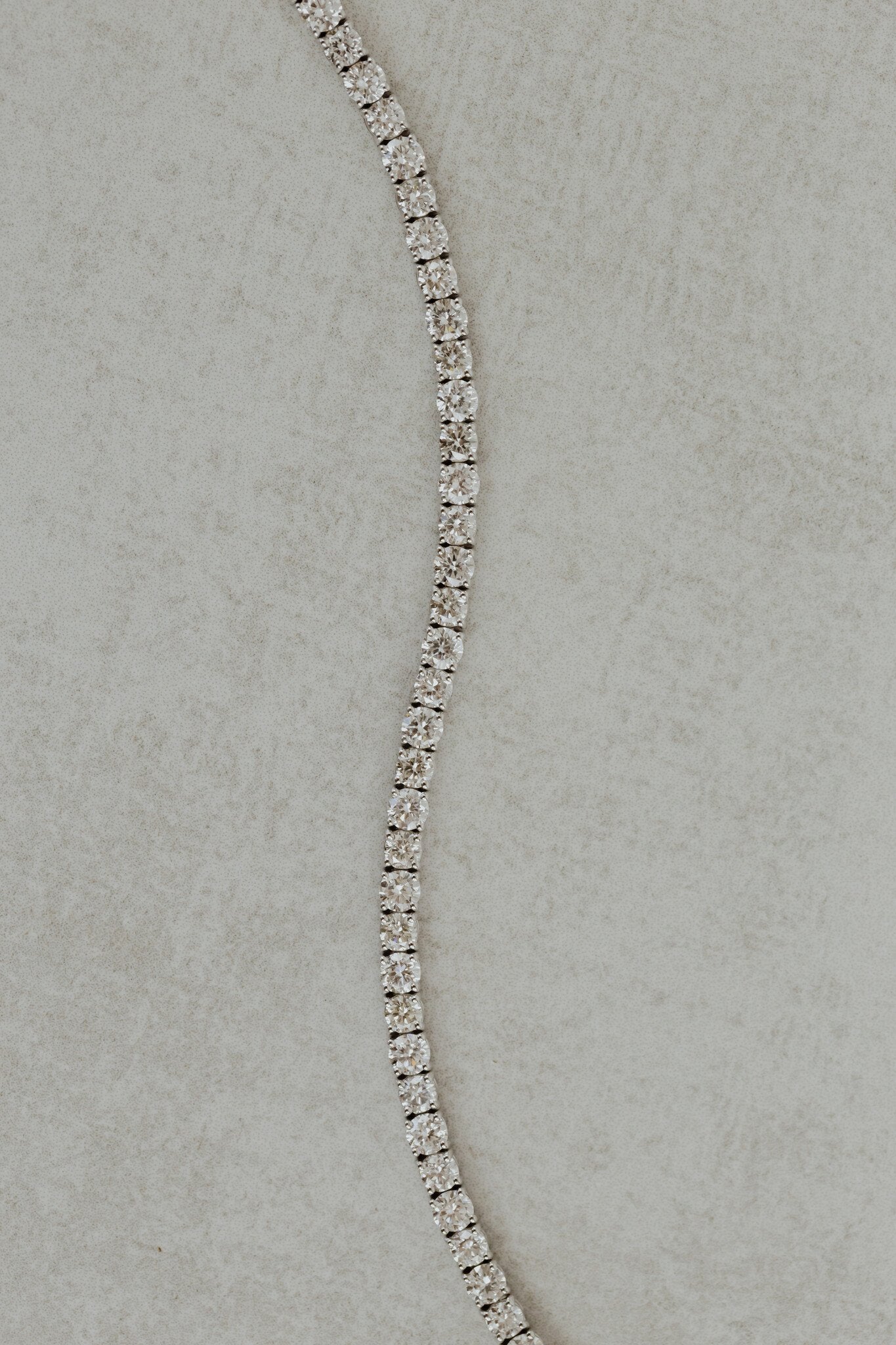 Close up a white gold signature diamond tennis bracelet.