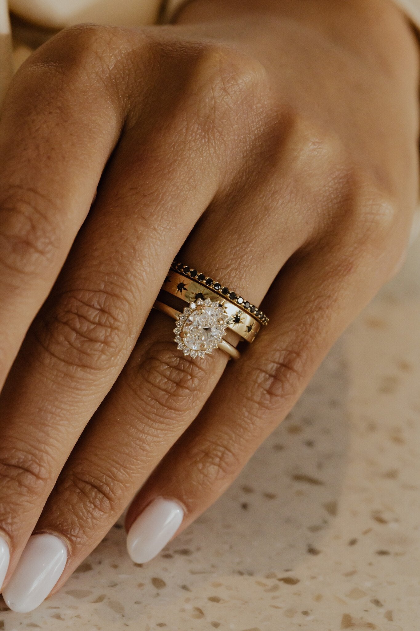 The Jenna Black Diamond Band paired with The Estelle Round Black Diamond Band on a models hand