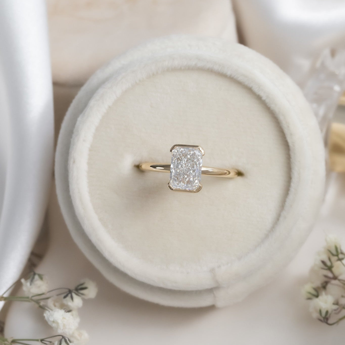 The Zadie Radiant Cut Half Bezel Solitaire Ring in a Sarah O Ring Box