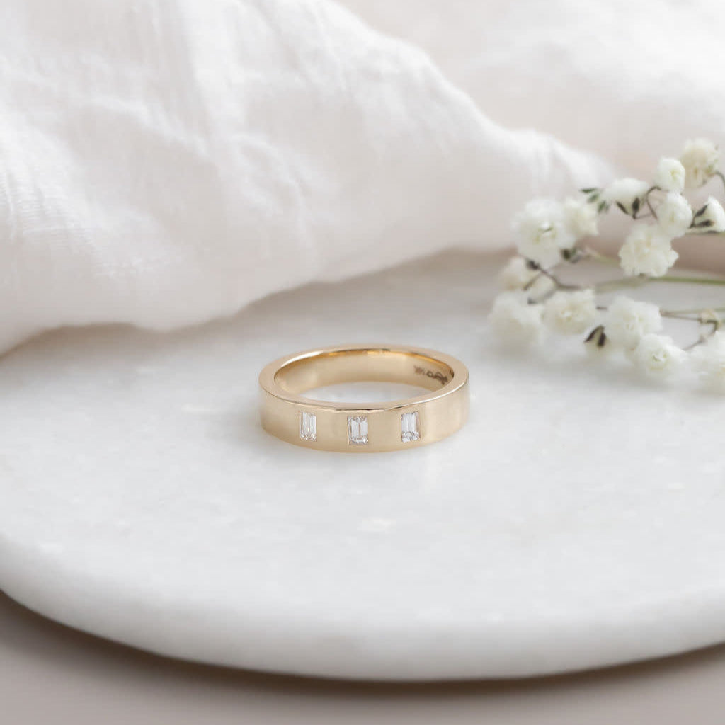 The Jaden Three Baguette Wedding Band in 14k yellow gold